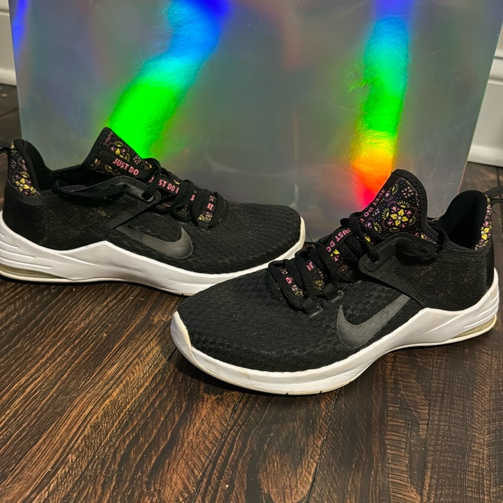 Nike womens air running/athletic shoe. Black with white bottom and floral design